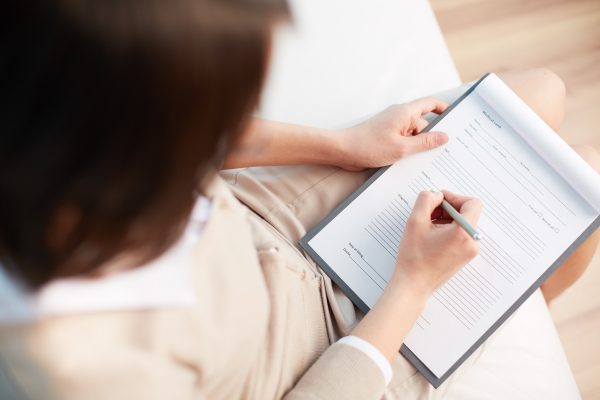 Female counselor writing down some information about her patient