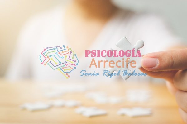 Hand of male trying to connect pieces of white jigsaw puzzle on wooden table. Healthcare for alzheimer disease, dementia, memory loss, autism awareness and mental health concept
